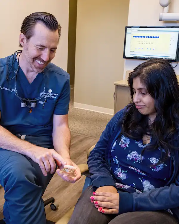 Dentist looking at implant options with patient