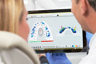 T-scan image with Doctor showing scan to a patient.