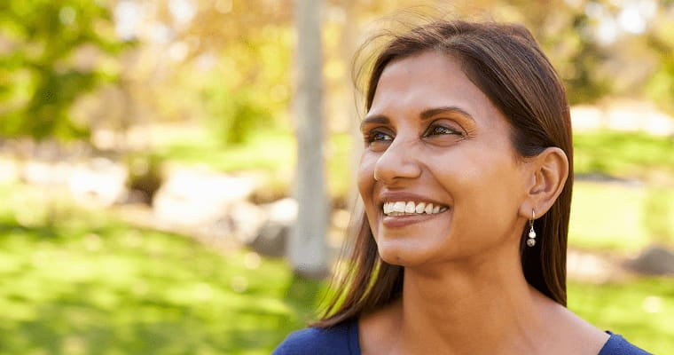 A woman smiles after her dental treatment